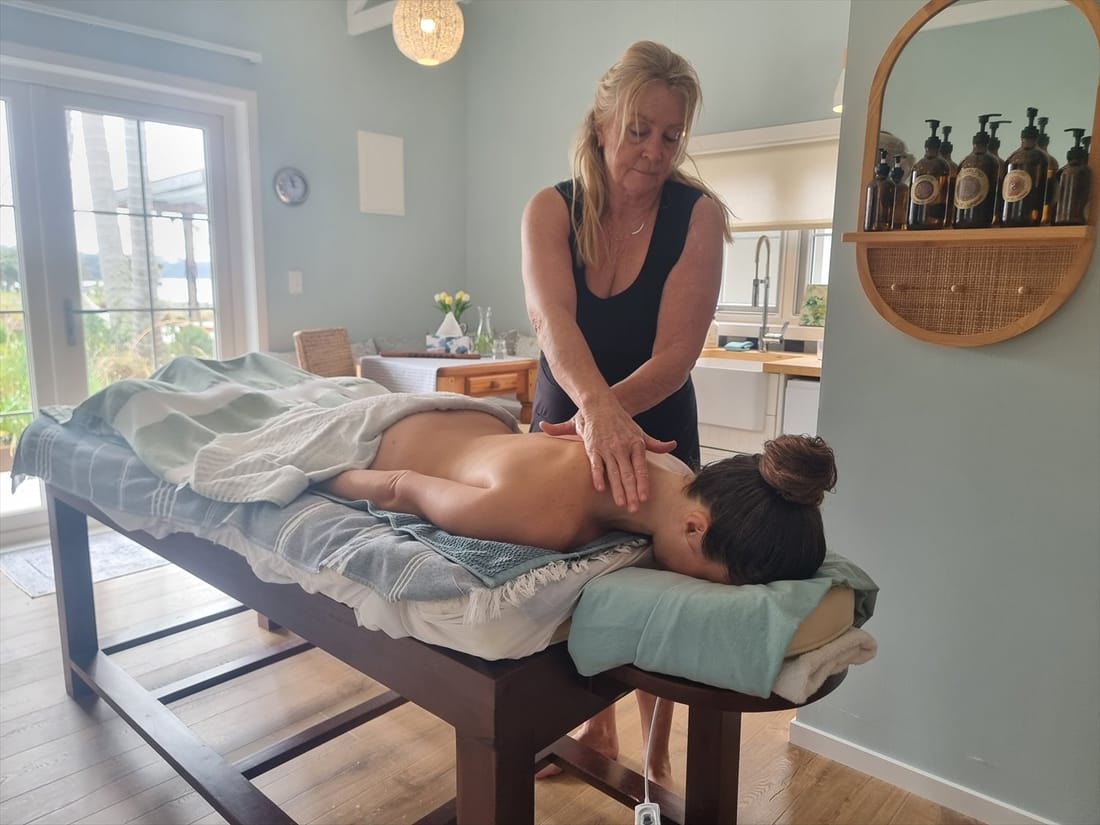 Bette giving a massage in the beach cottage